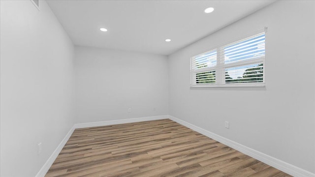 empty room with hardwood / wood-style flooring