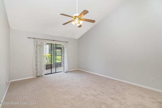 empty room with ceiling fan, high vaulted ceiling, and light colored carpet