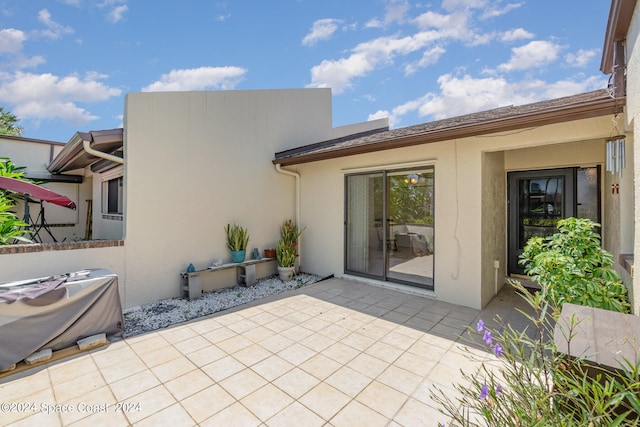 back of property with a patio