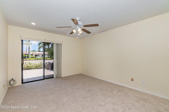 unfurnished room with baseboards, a textured ceiling, and light colored carpet