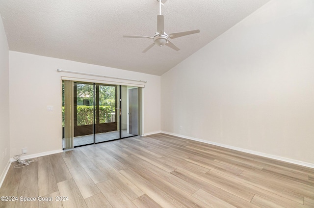 unfurnished room featuring light wood finished floors, lofted ceiling, a ceiling fan, a textured ceiling, and baseboards