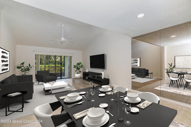 living room featuring ceiling fan, a textured ceiling, and lofted ceiling