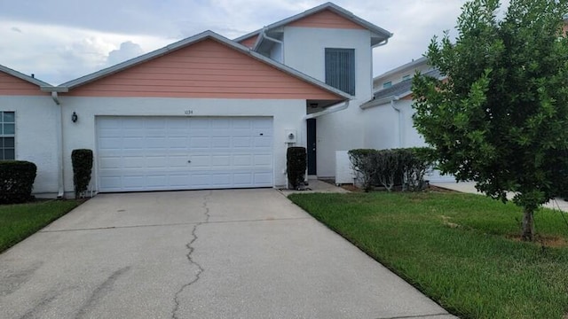 view of front of home featuring a garage and a front yard