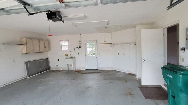 garage with a garage door opener and sink