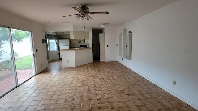 unfurnished living room featuring ceiling fan