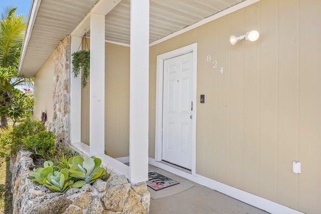 view of exterior entry featuring a porch