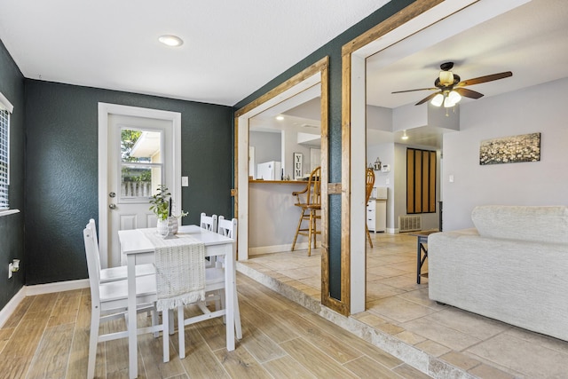 dining space with light tile patterned floors and ceiling fan