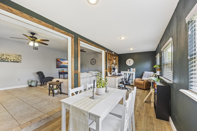 dining space with hardwood / wood-style floors and ceiling fan