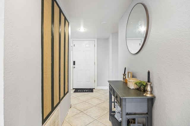 hall with light tile patterned floors