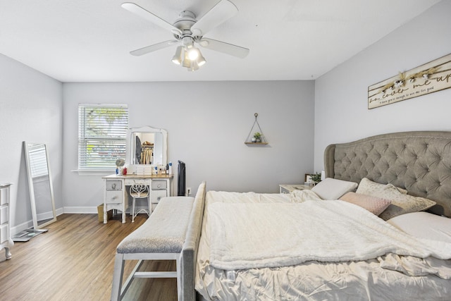 bedroom with hardwood / wood-style floors and ceiling fan