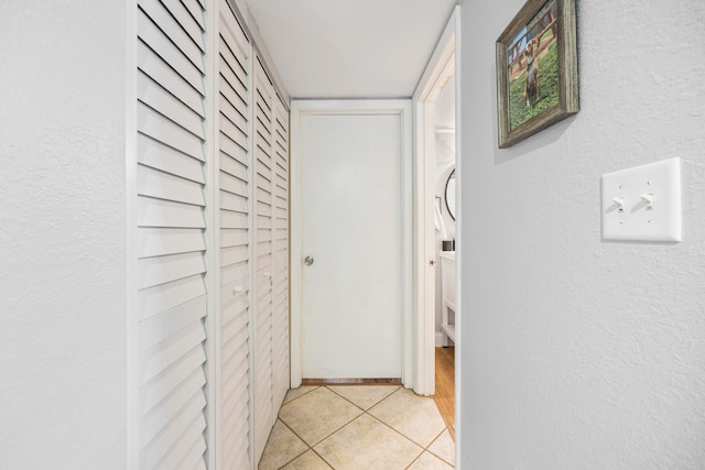 hall featuring light tile patterned floors