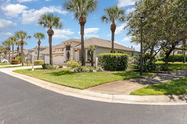 view of front of property featuring a garage and a front lawn