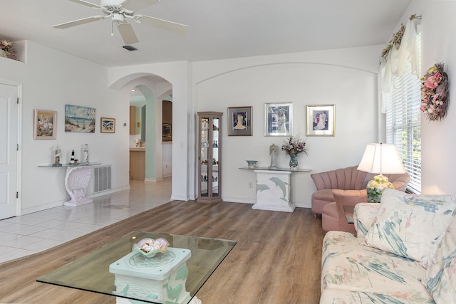 living room with wood-type flooring and ceiling fan