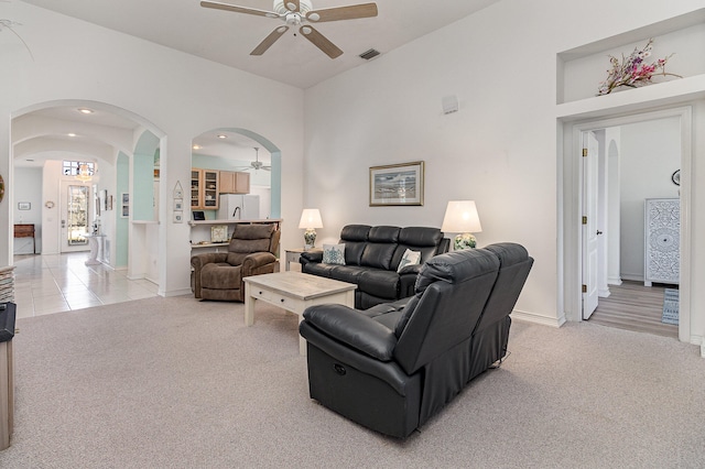 carpeted living room with ceiling fan