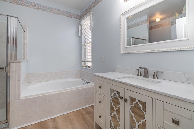 bathroom featuring vanity, hardwood / wood-style floors, and independent shower and bath