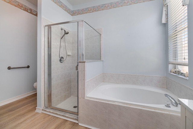 full bathroom featuring vanity, hardwood / wood-style floors, plus walk in shower, and toilet