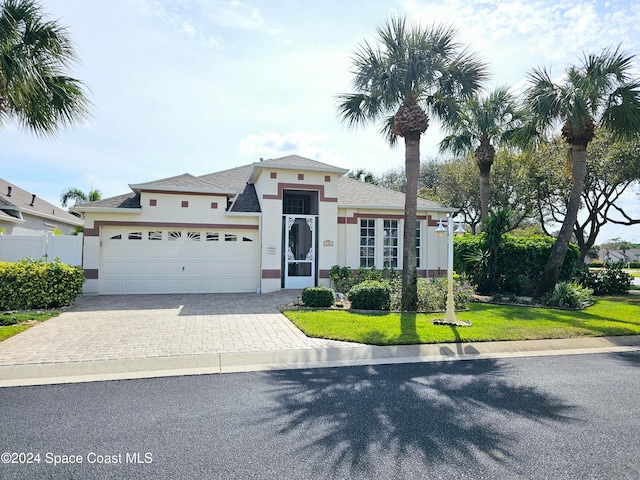 view of front facade featuring a front lawn and a garage