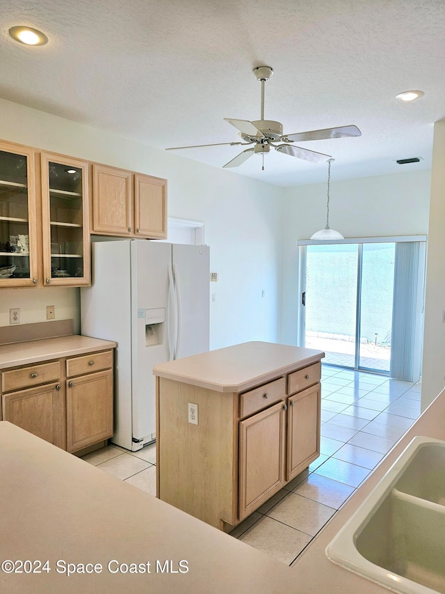 kitchen featuring light brown cabinetry, light tile patterned flooring, ceiling fan, and white fridge with ice dispenser