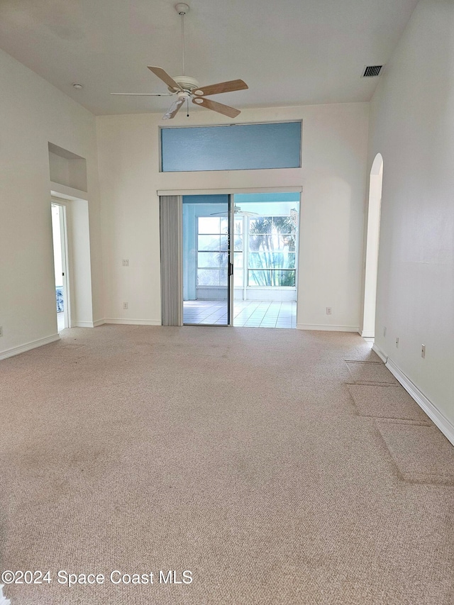 unfurnished living room with light carpet and ceiling fan