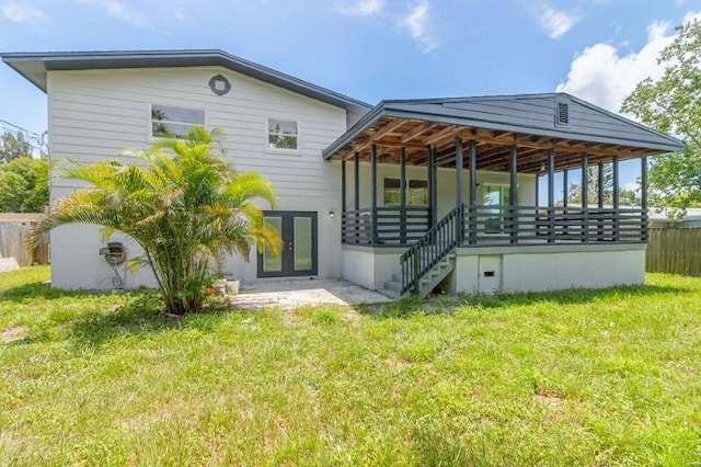 back of property with french doors, stairway, fence, a yard, and a patio area