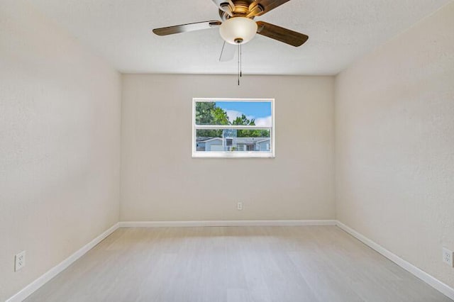 spare room with light wood-style flooring and baseboards