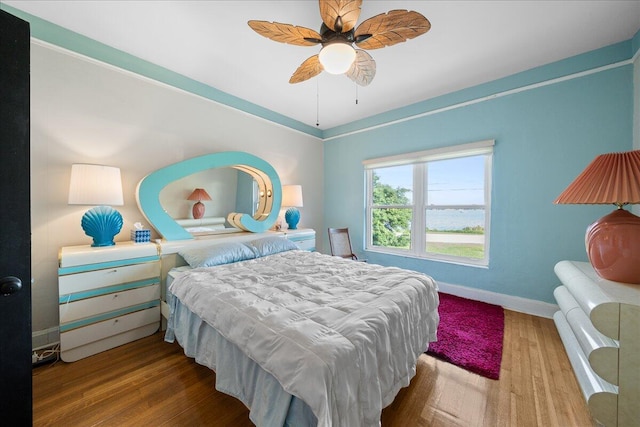 bedroom with hardwood / wood-style floors and ceiling fan