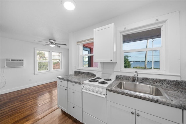 kitchen with an AC wall unit, sink, white cabinets, dark hardwood / wood-style flooring, and electric stove