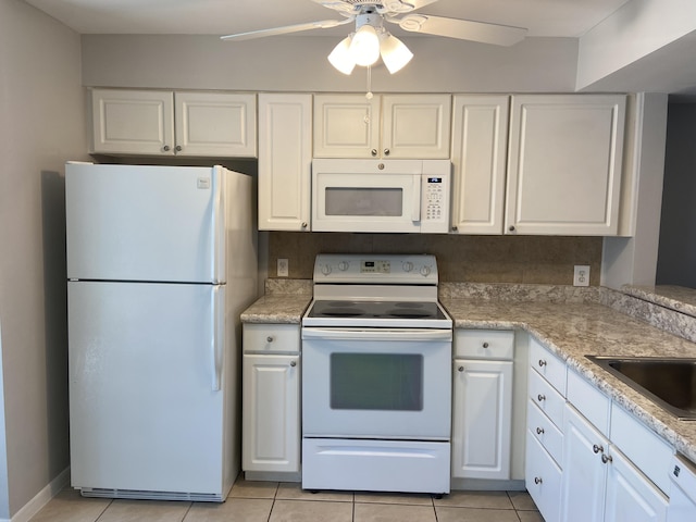 kitchen featuring sink, white appliances, ceiling fan, white cabinetry, and light tile patterned flooring