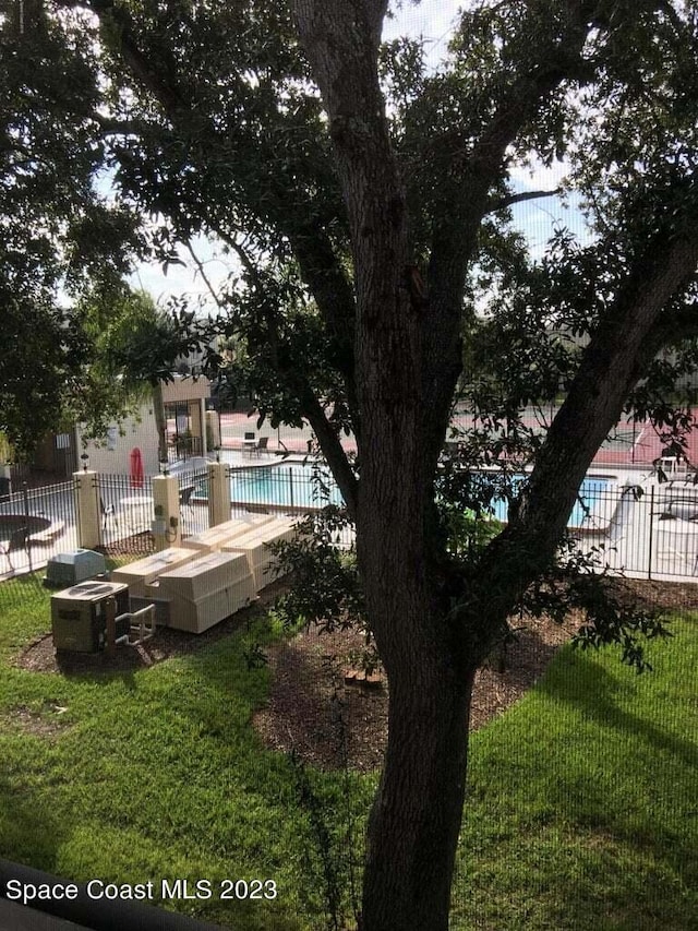 view of yard featuring a community pool