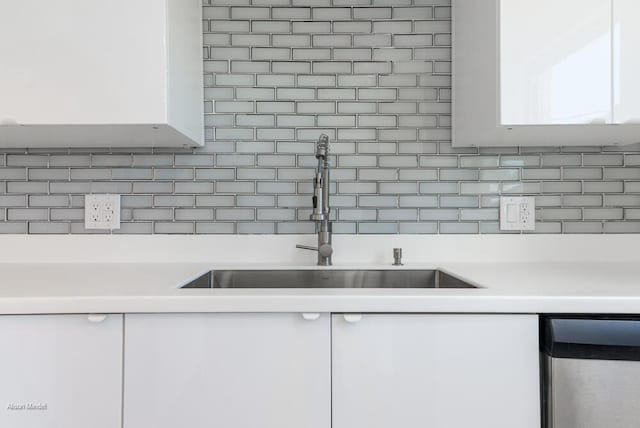 kitchen with white cabinetry, sink, and decorative backsplash