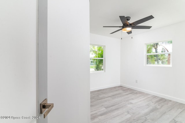 unfurnished room featuring ceiling fan, plenty of natural light, and light hardwood / wood-style floors