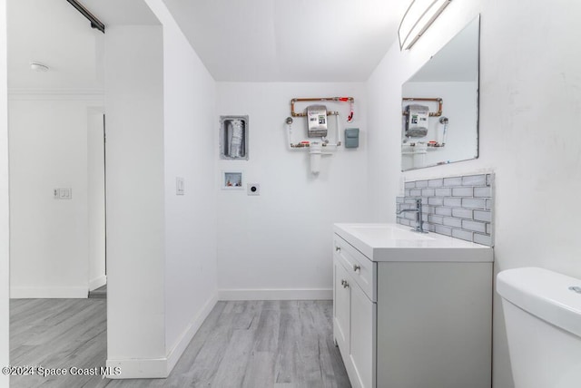 bathroom featuring vanity, hardwood / wood-style floors, and toilet