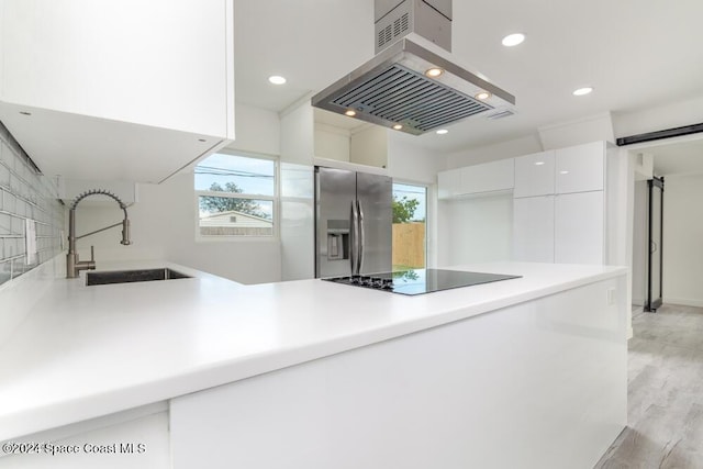 kitchen with white cabinetry, sink, island exhaust hood, stainless steel refrigerator with ice dispenser, and black electric cooktop