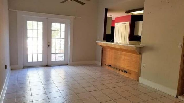 doorway to outside featuring light tile patterned floors, french doors, and ceiling fan