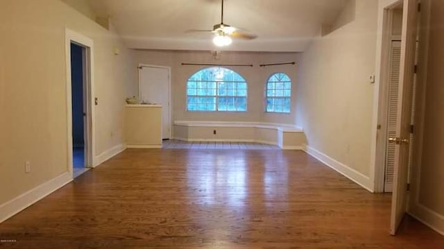 unfurnished room with dark hardwood / wood-style floors and ceiling fan