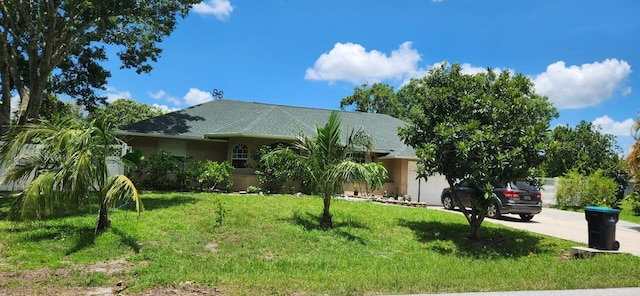 view of front of property with a garage and a front lawn