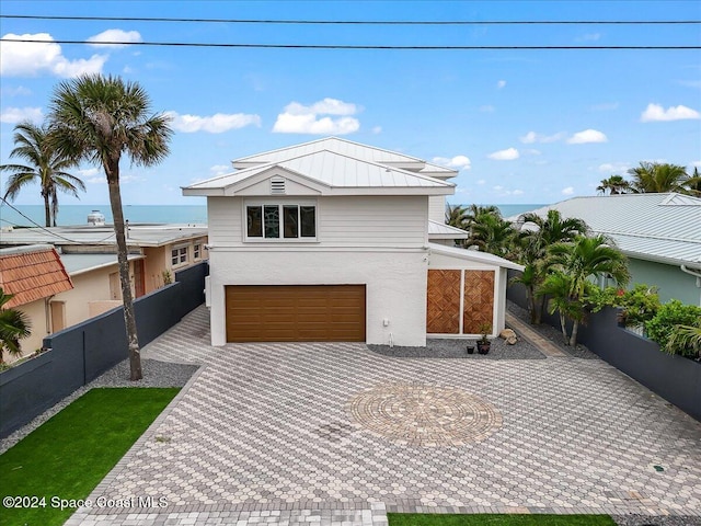 view of front of house featuring a water view and a garage