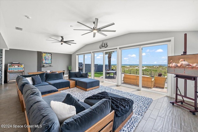 living room with hardwood / wood-style flooring, ceiling fan, and lofted ceiling