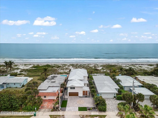 birds eye view of property featuring a water view and a view of the beach