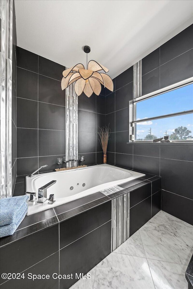 bathroom featuring tiled bath and tile walls