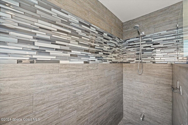 bathroom featuring a shower and a textured ceiling