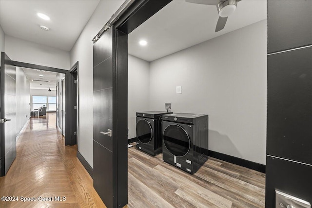 interior space featuring washer and dryer, a barn door, and ceiling fan