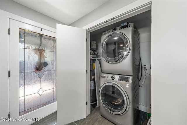 clothes washing area featuring dark hardwood / wood-style floors and stacked washer and dryer