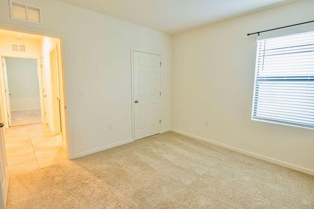 carpeted empty room featuring plenty of natural light