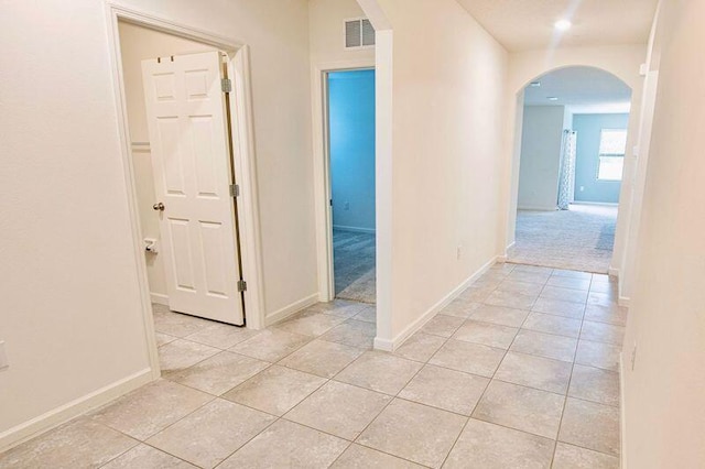 hall with light tile patterned floors