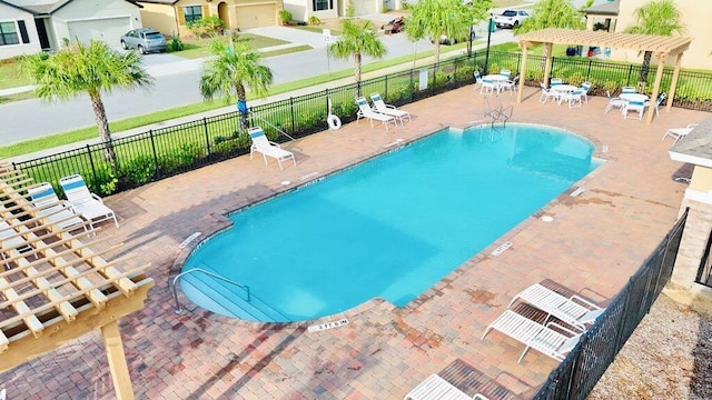 view of swimming pool with a pergola and a patio