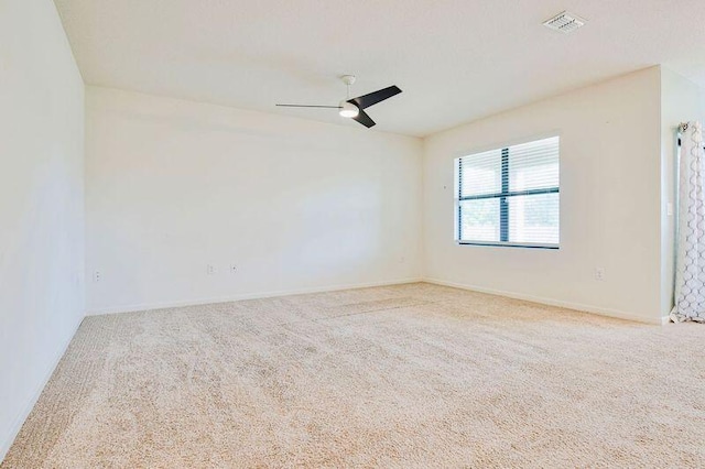 empty room with ceiling fan and carpet flooring