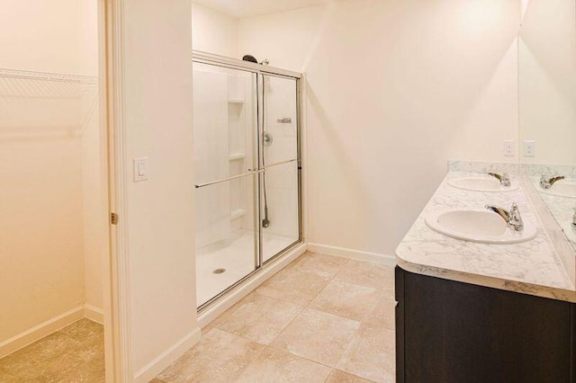 bathroom with tile patterned floors, vanity, and an enclosed shower