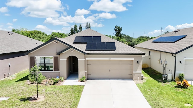 view of front of property featuring a garage, a front yard, and solar panels