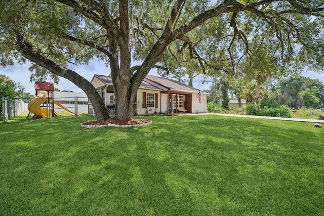 ranch-style house with a front lawn and a playground